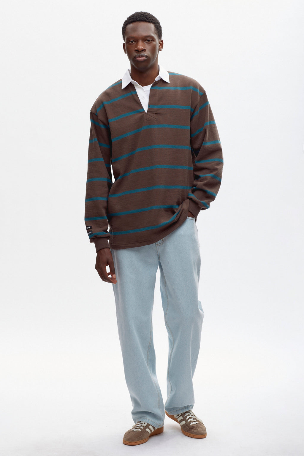 Rukundo is 6'1, is a regular L and is wearing an L.